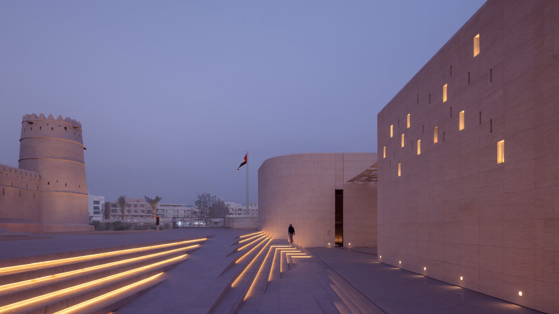 Twilight view of illuminated museum architecture and steps